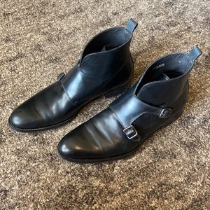 SuitSupply black leather boots with buckles.